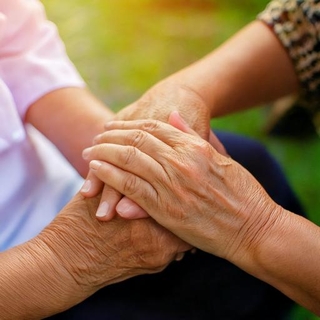 comforting a older person's hands, receiving comfort from her doctors